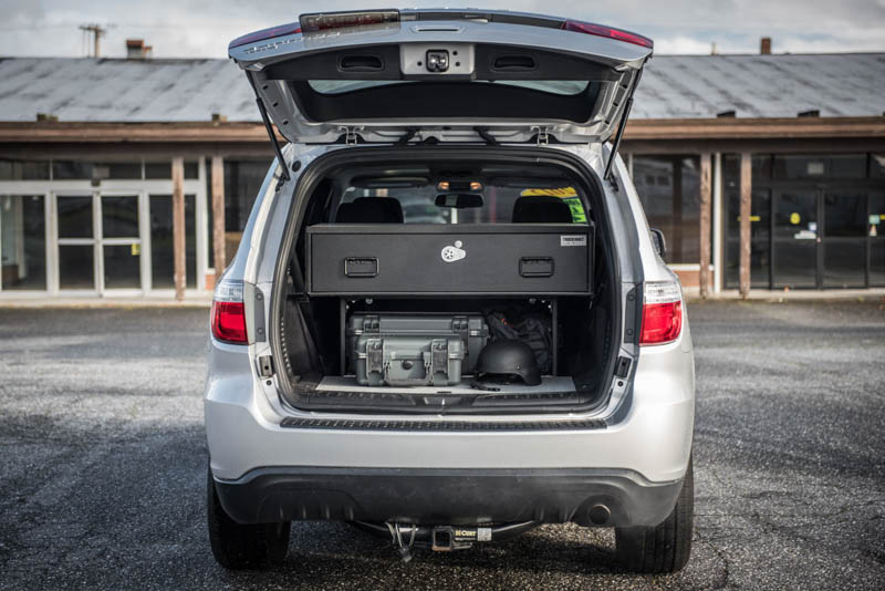 A silver Dodge Durango with a TruckVault in the cargo space for secure storage.