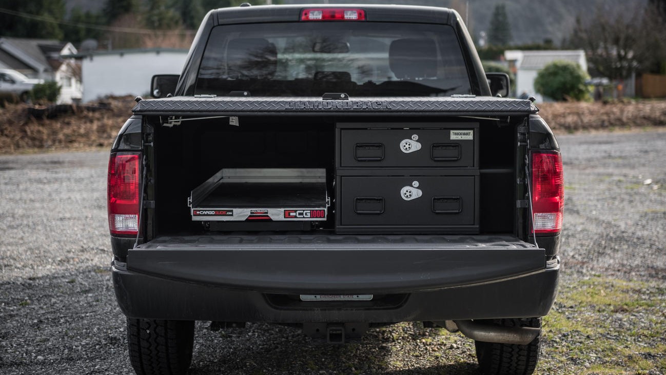 A Dodge Ram with a Covered Bed half-width TruckVault secure storage system and a CargoGlide.