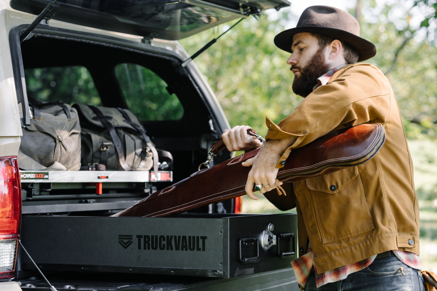 A man putting his firearm into his TruckVault.