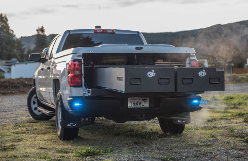 A white Chevy Silverado with a TruckVault in the bed.