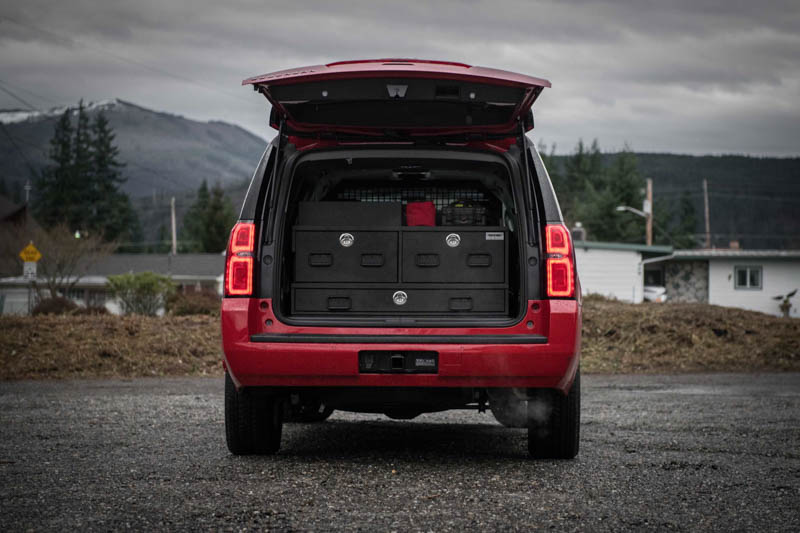 A red Chevy Suburban fire department vehicle with a TruckVault in the cargo space for secure storage.