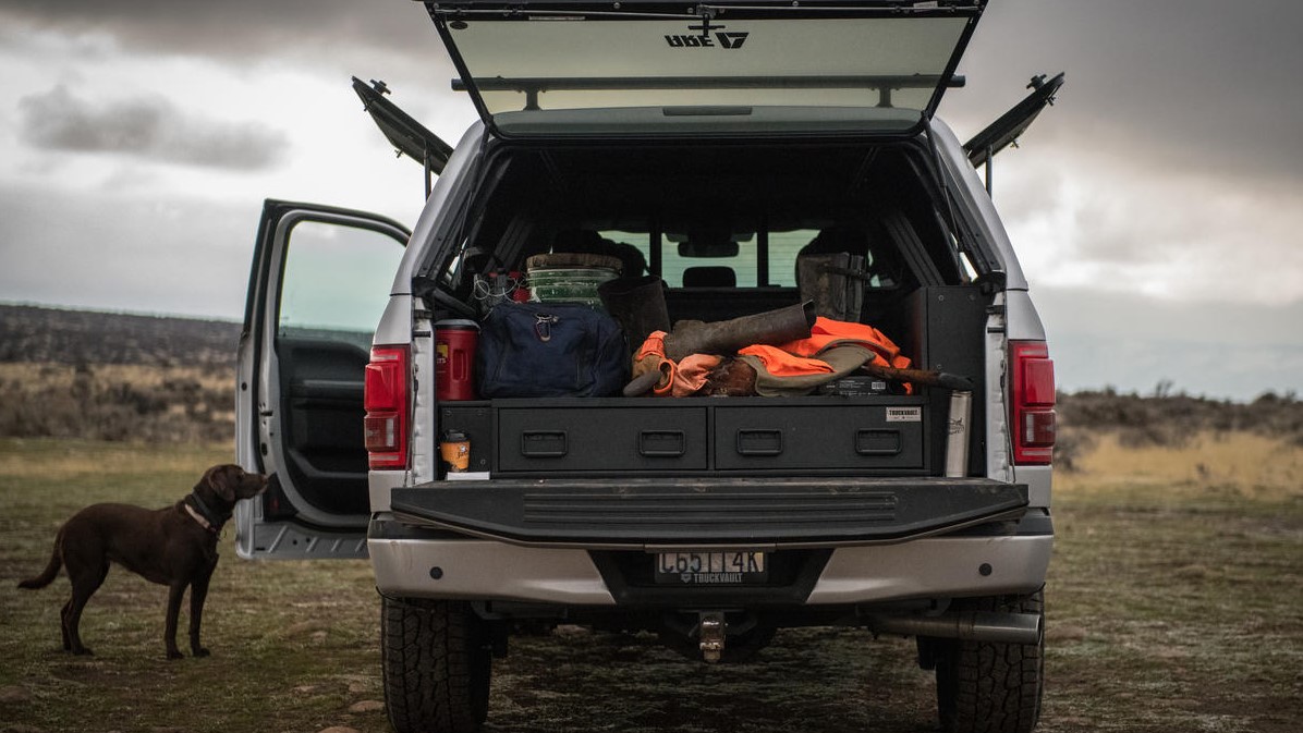 A Ford F150 with a fob lock Covered Bed TruckVault in the bed.