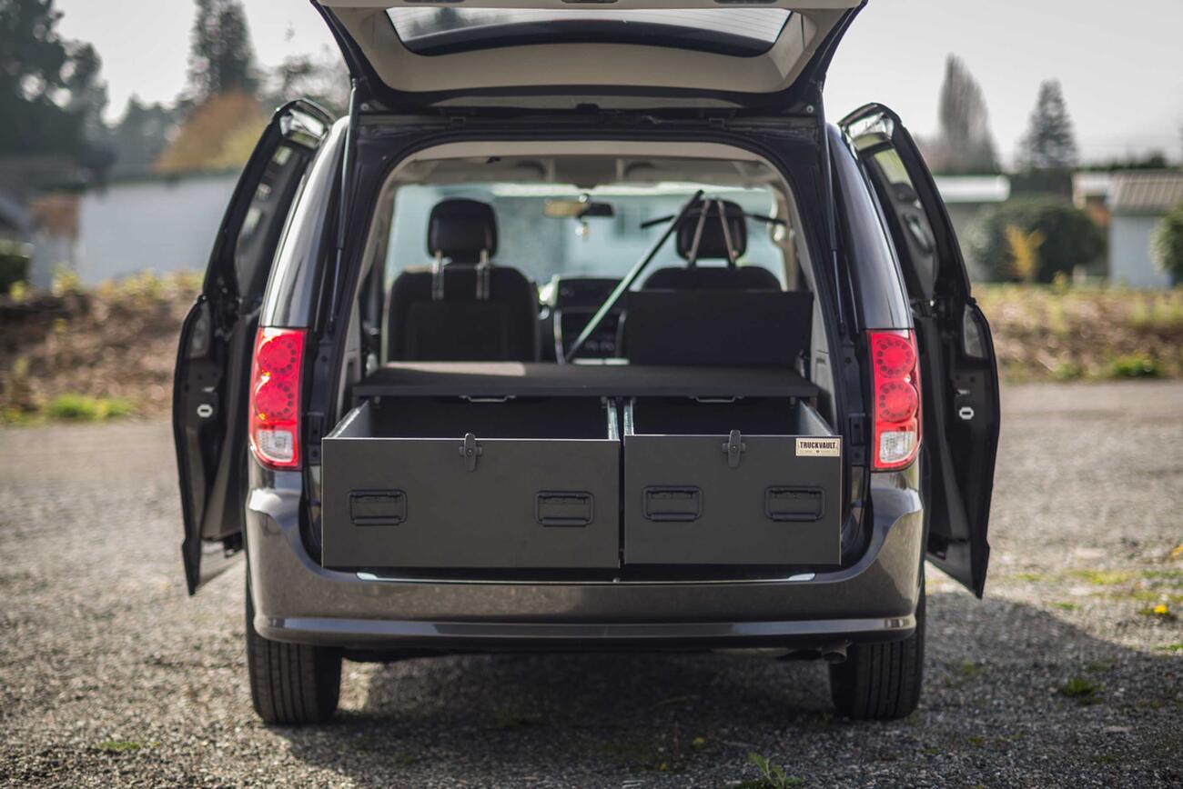 The back of a black Dodge Caravan with a magnum height TruckVault 