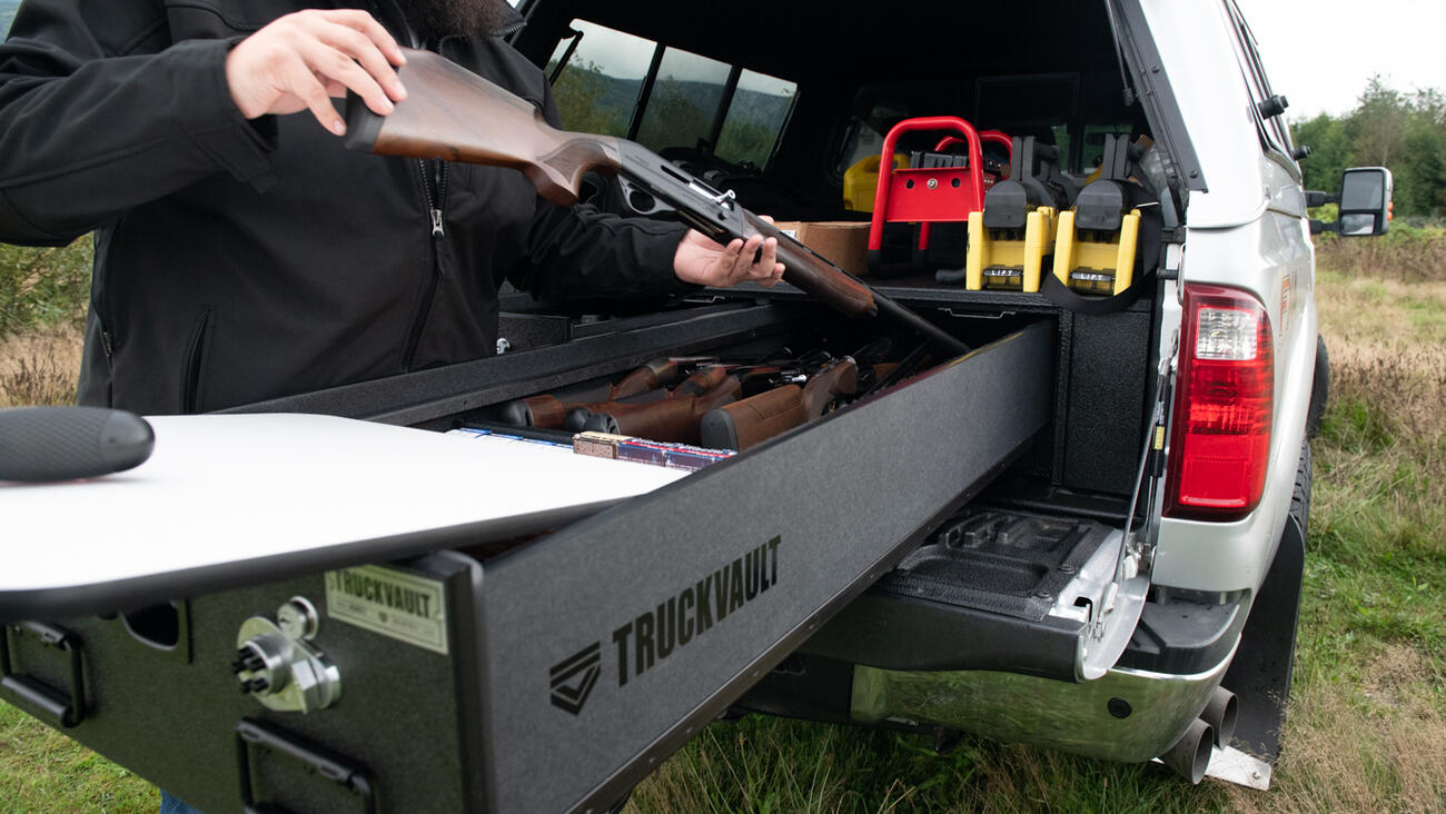A man taking his rifle out of his TruckVault.