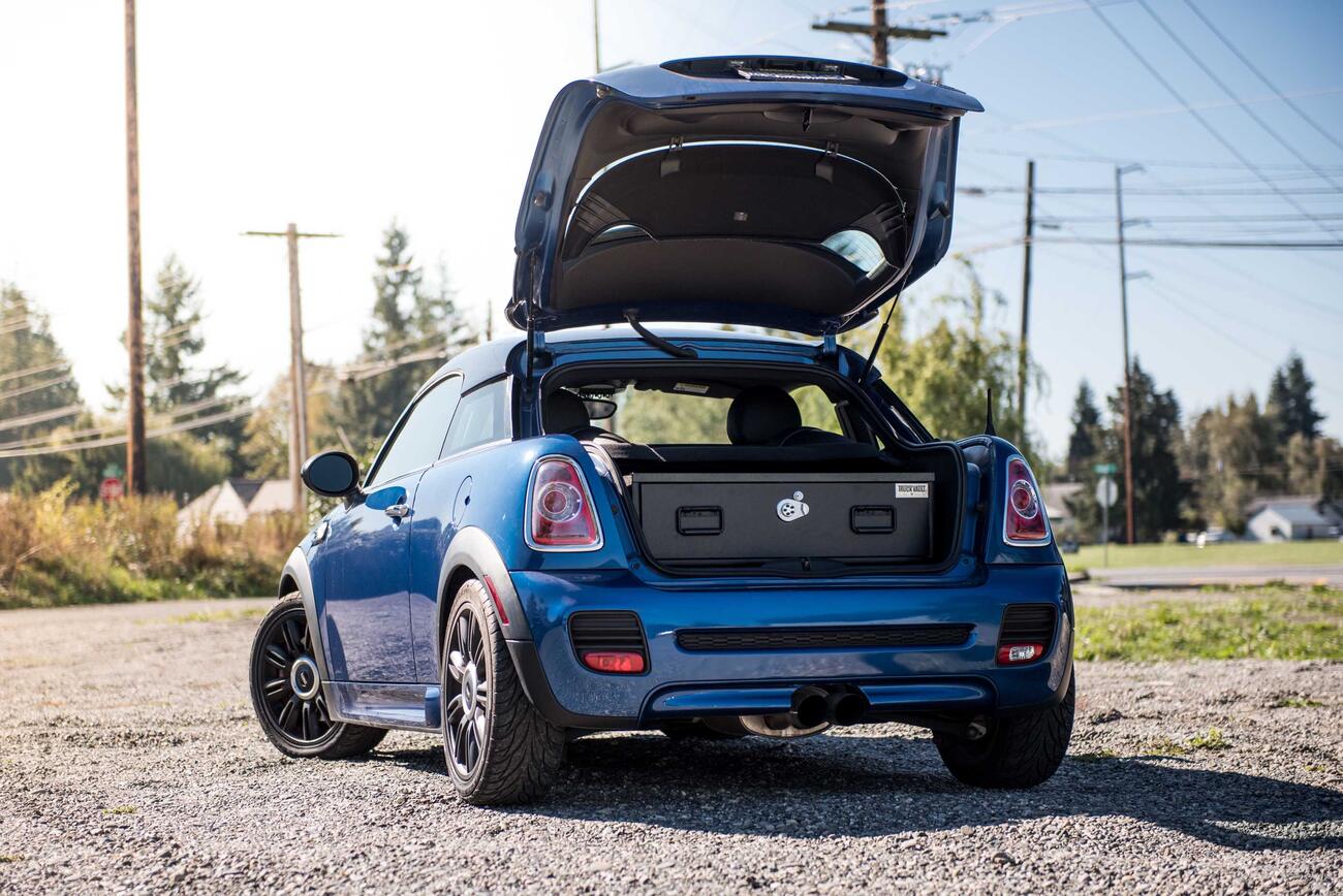 MiniCoop-2.jpg A blue Mini Cooper with an elevated TruckVault in the cargo space.
