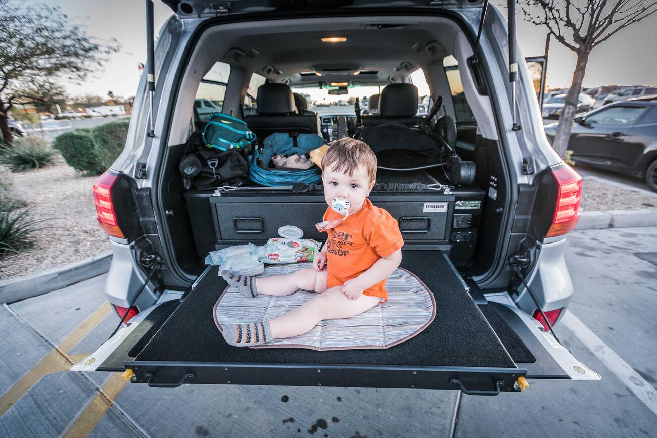 SeanJennings_Baby1 A baby sitting on a heavy duty pull out table in a Lexus LX570.