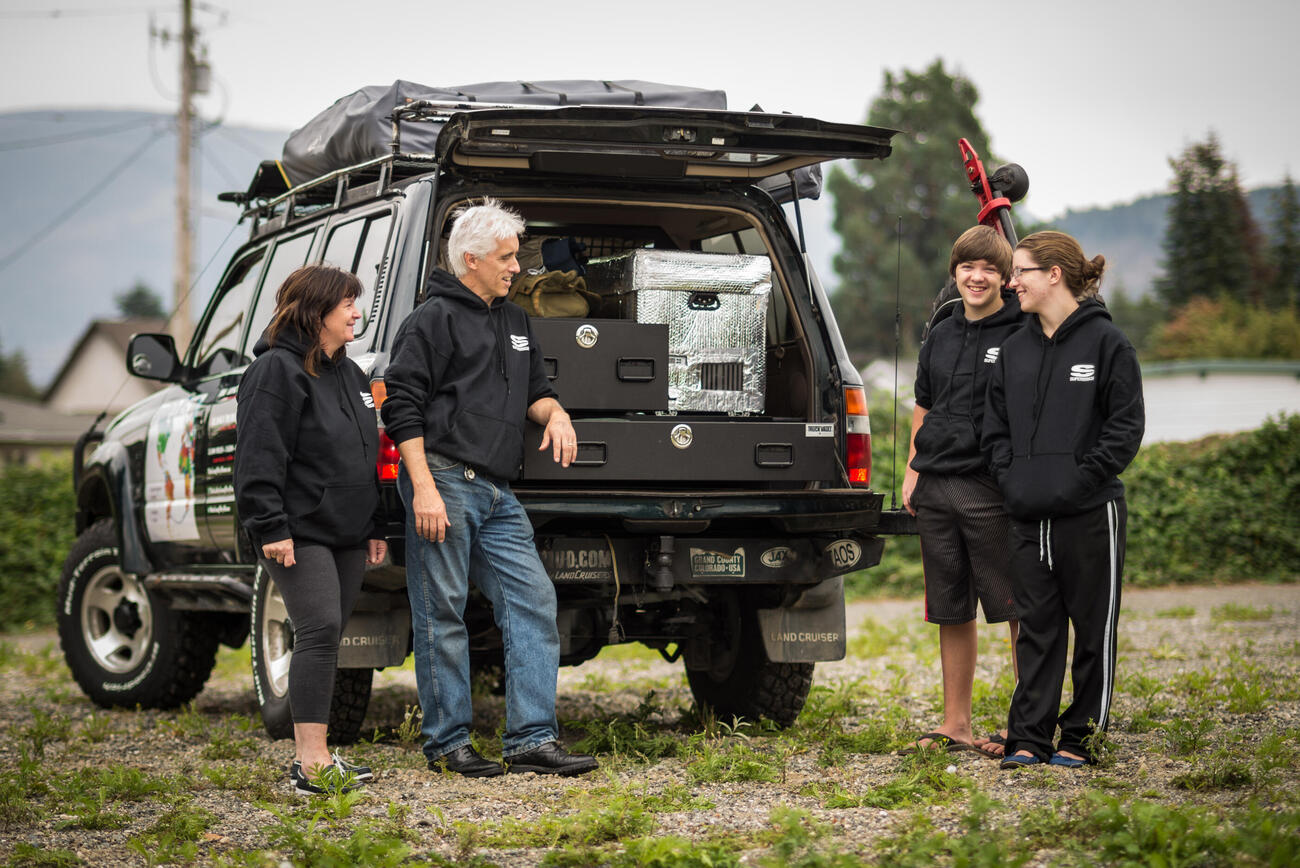 Family using a custom TruckVault storage system for overlanding. 