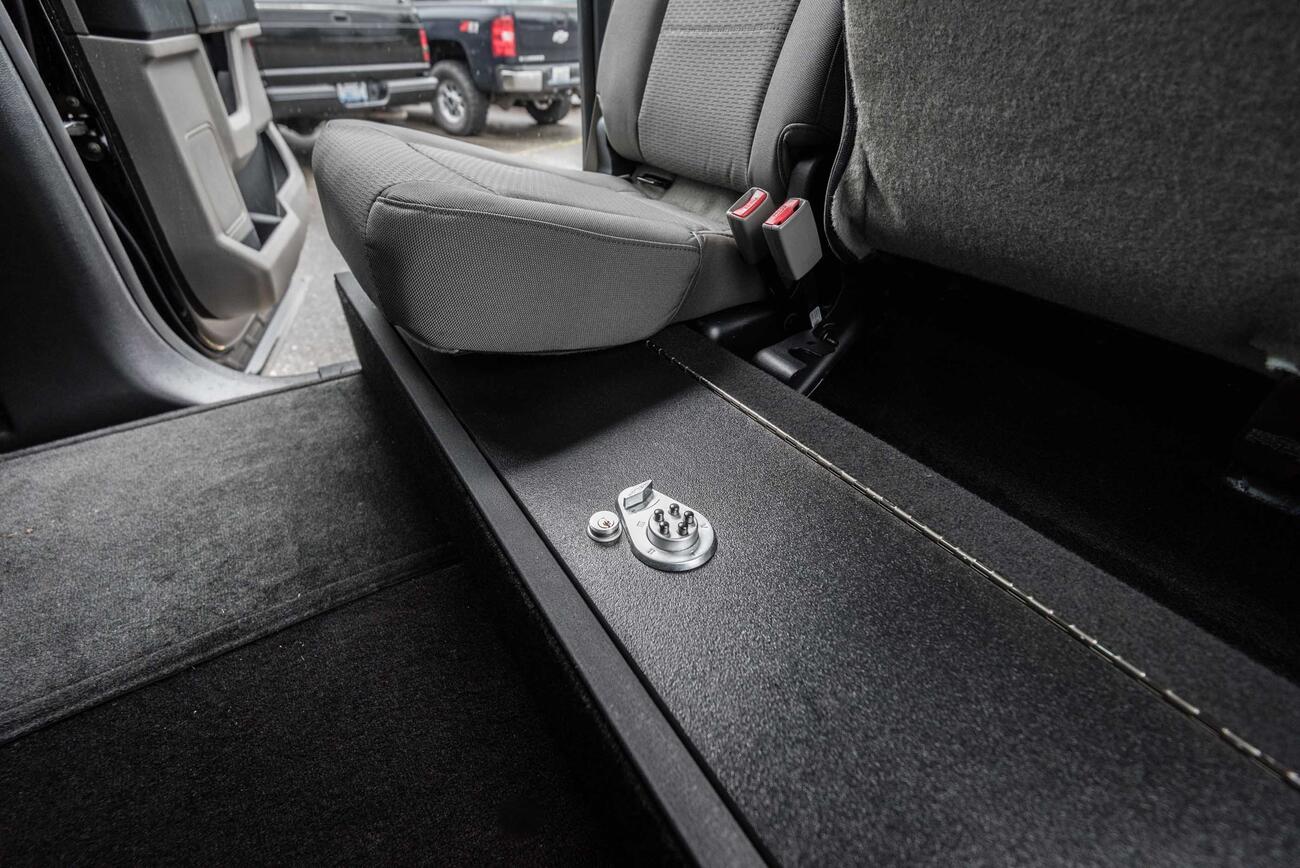 PickUpSeries_InteriorCabLine_SeatVault_Ford_F150_McInturf-3.jpg A SeatVault in the back of a Ford F150 with one seat folded down.