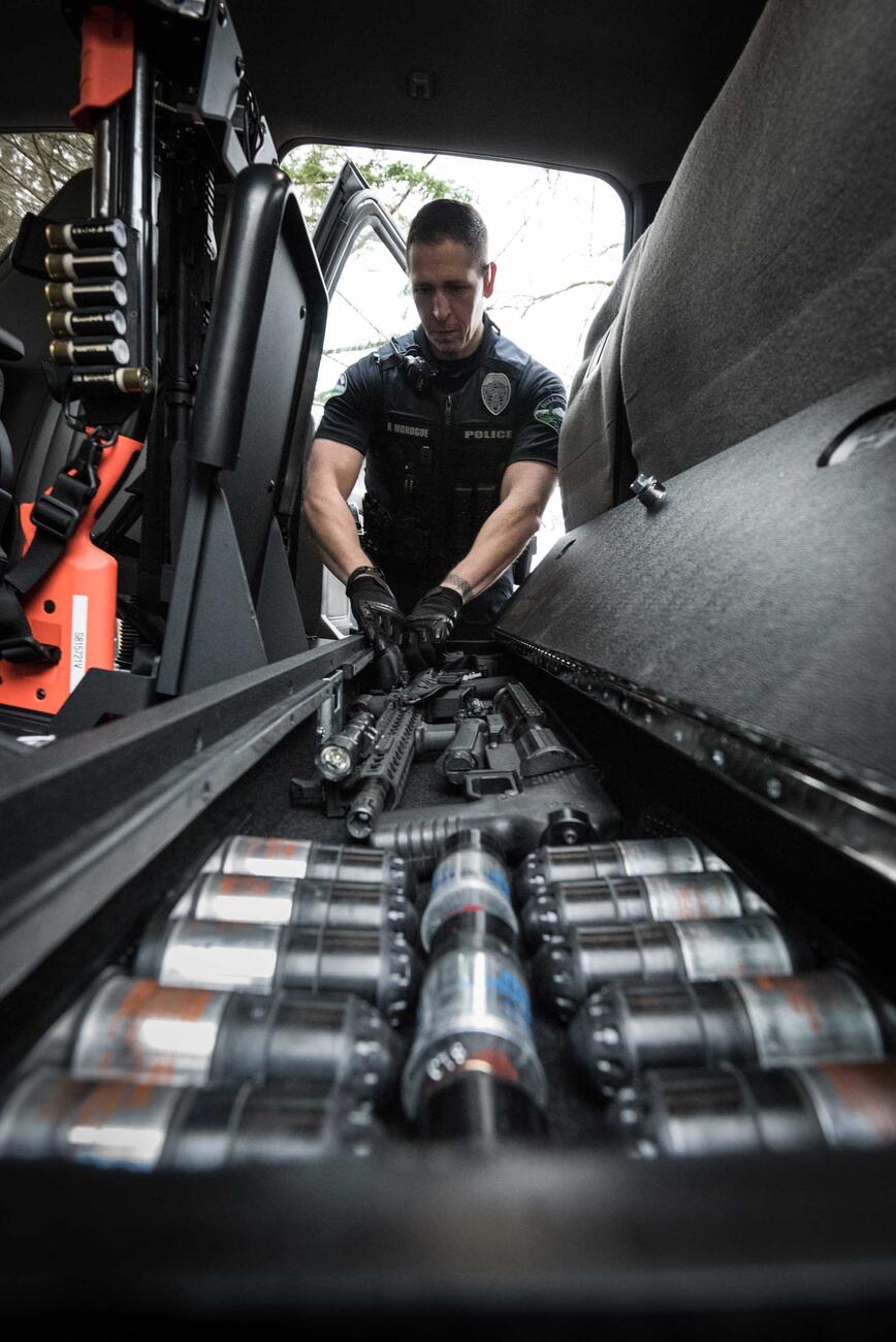 A police officer taking his gun out of his SeatVault.