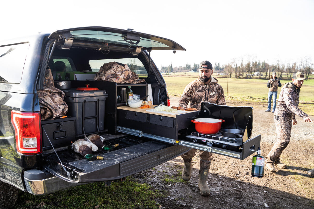 Hunter cooking out of TruckVault Base Camp line 5