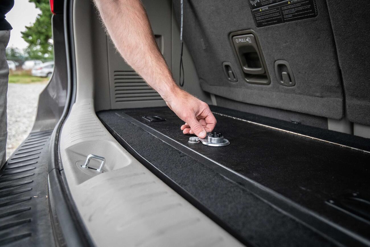 A man unlocking a Kia Sedona FloorVault.