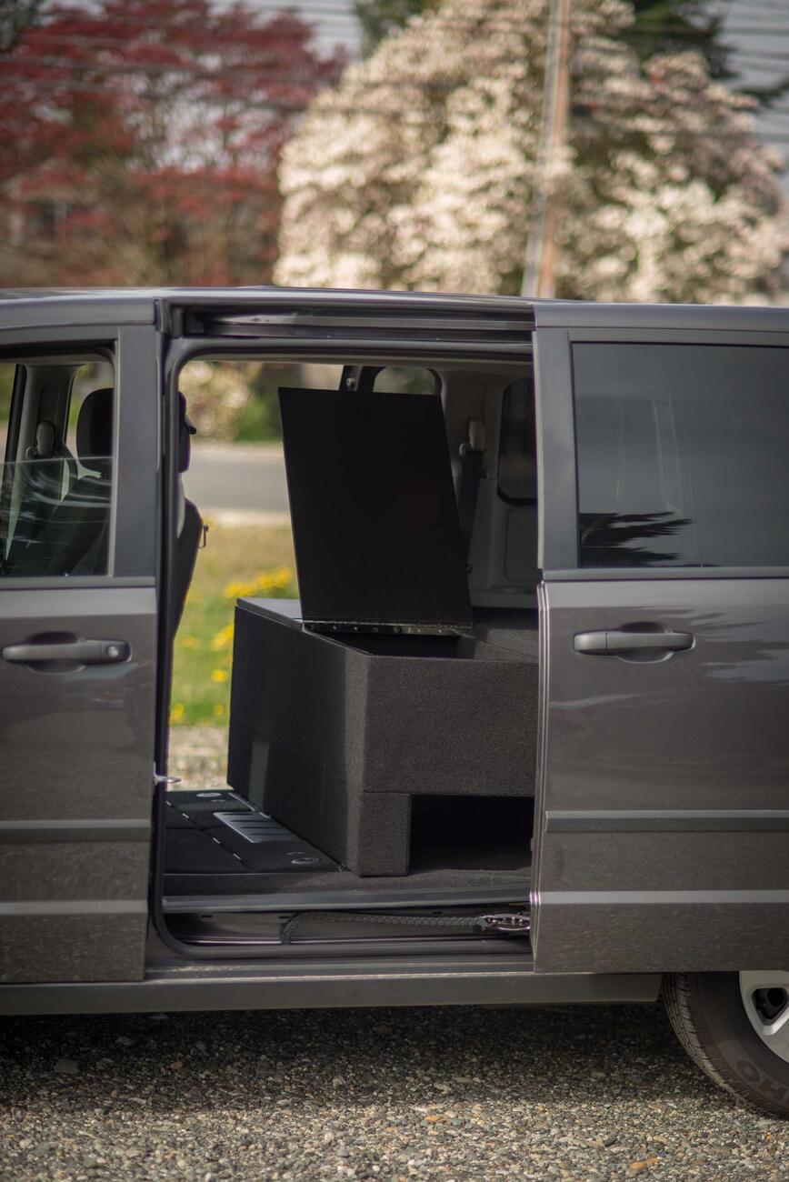 The side of a Dodge Grand Caravan with a custom TruckVault. 