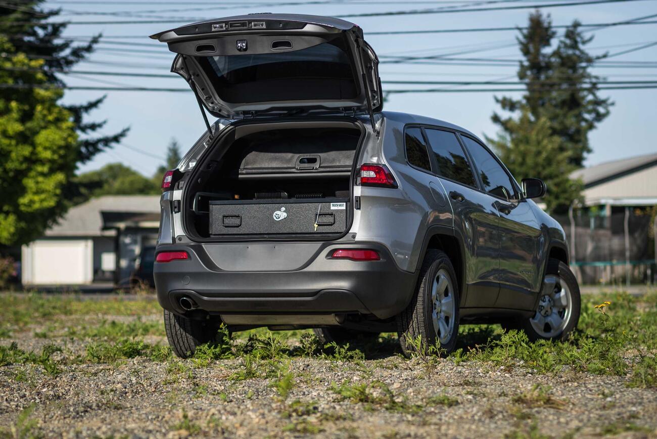 A Truckvault in the back of a Gray Jeep Grand Cherokee.