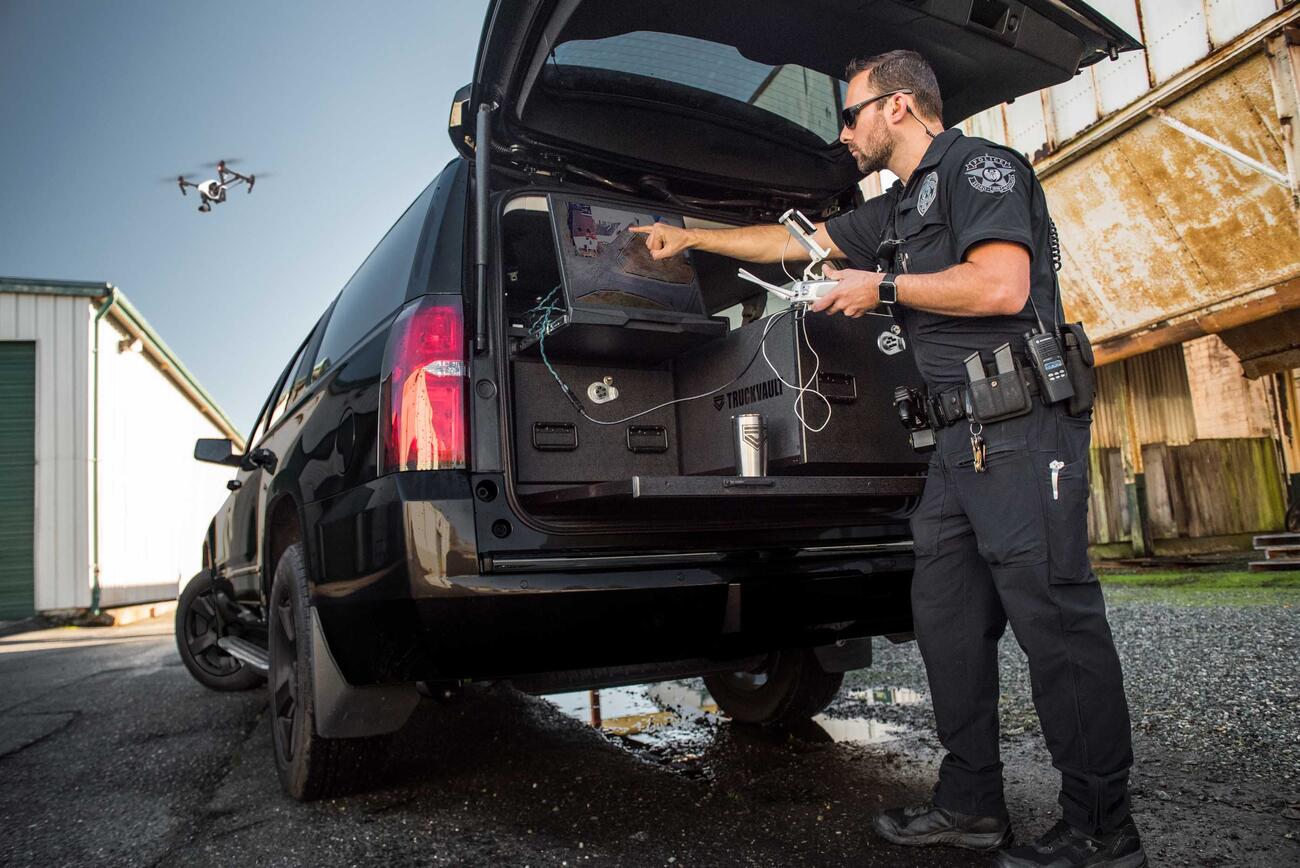 A police officer flying a drone using the built in screen in his TruckVault.