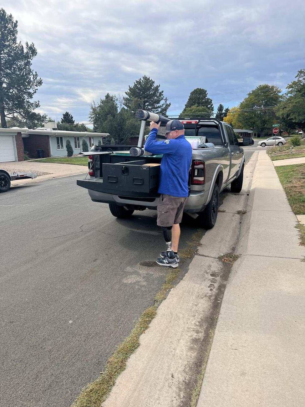 Dodge Ram Magnum 2 Drawer All Weather TruckVault In Use with Man Pulling Ladder from Drawer