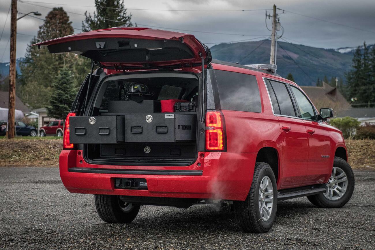 The back of an open fire department, Red Chevy Suburban with a custom TruckVault