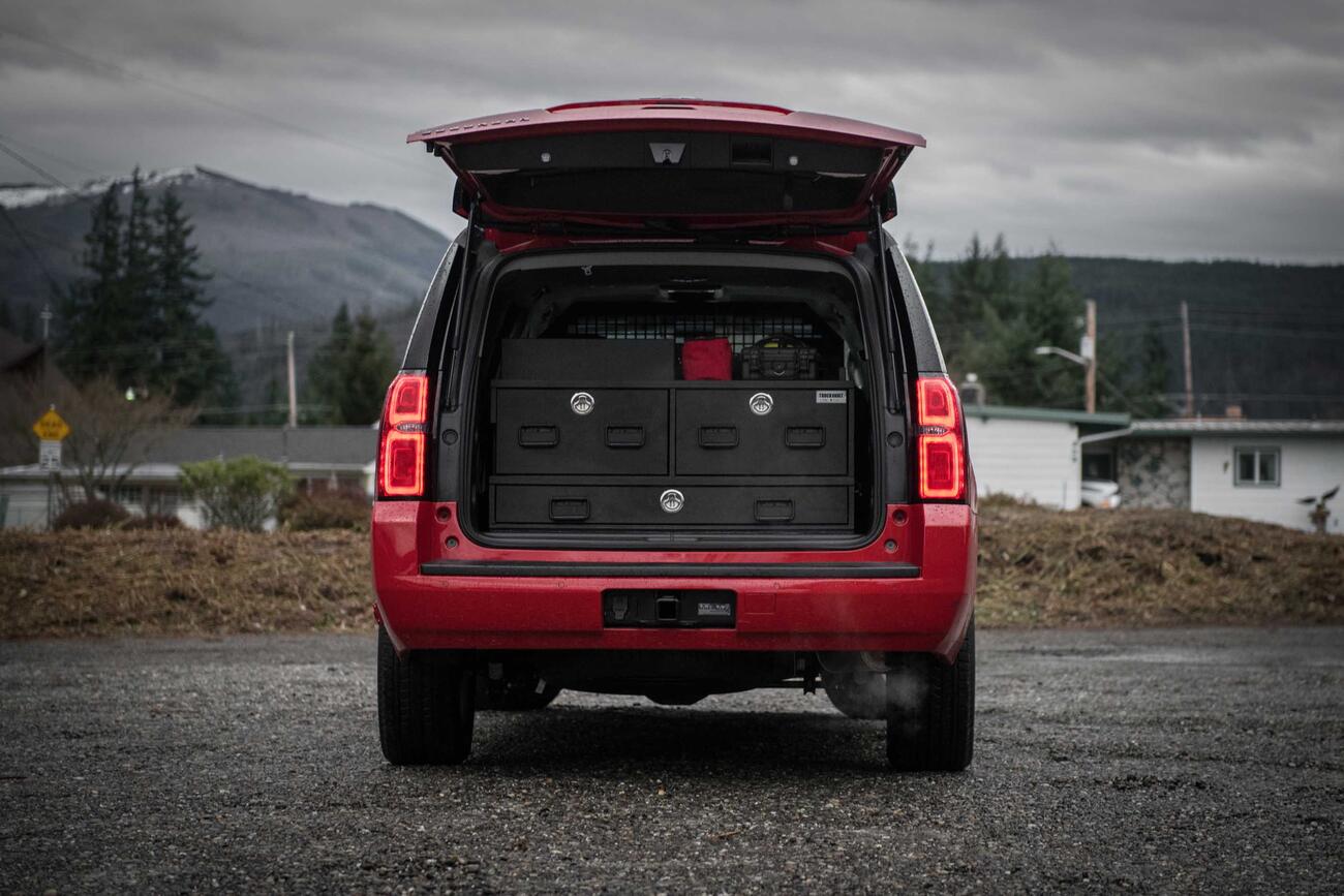 The back of an red, open fire department Chevy Suburban with a custom TruckVault.