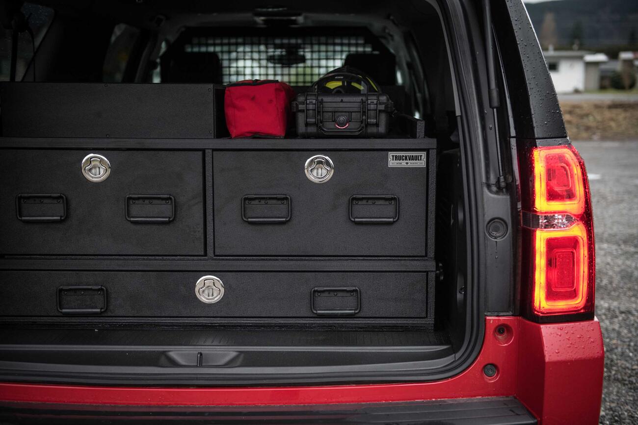 The back of an red, open fire department Chevy Suburban with a custom TruckVault.