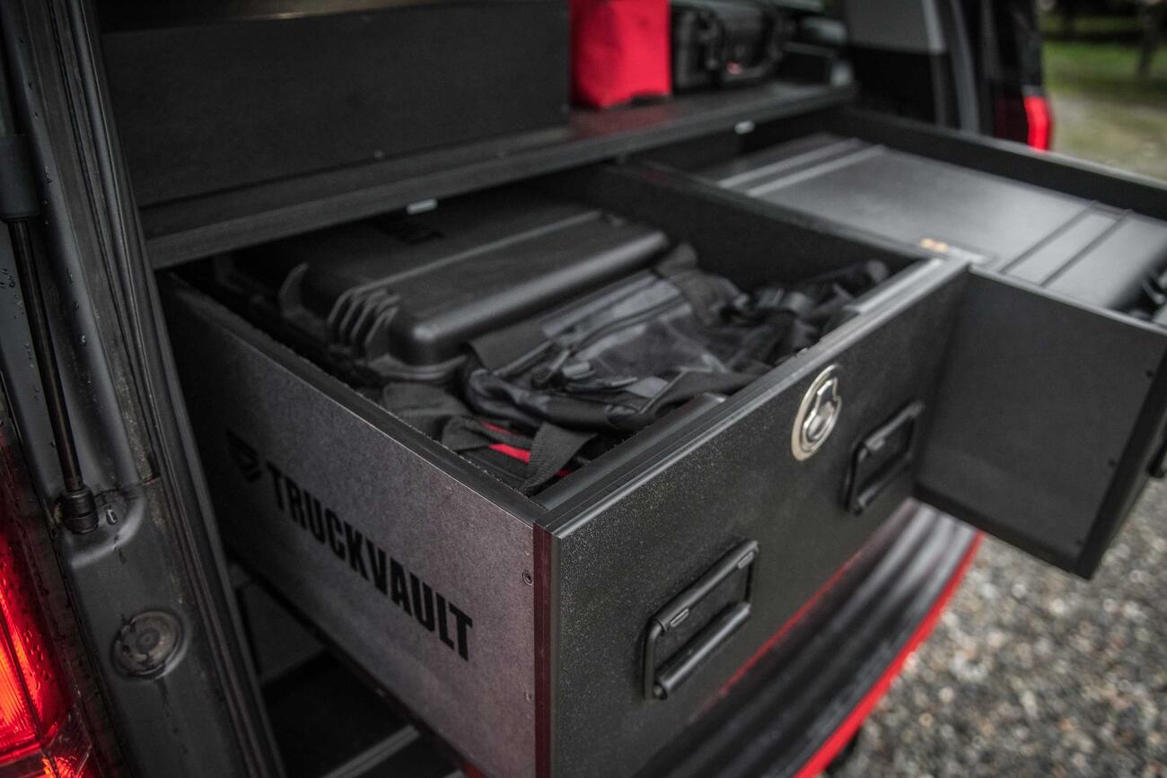 An up-close image of a custom, open TruckVault inside of a red Chevy Suburban.