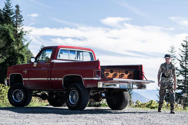 Man at tailgate with TruckVault