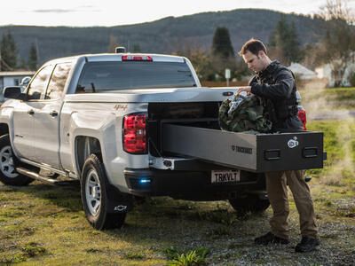 officer opening TruckVault secure truck bed storage drawer from back of Chevrolet Silverado