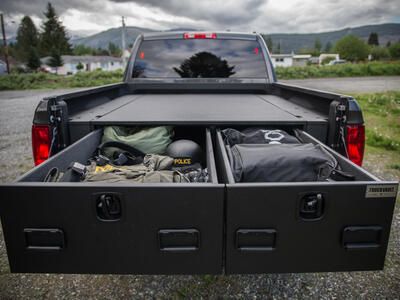 offset drawers extended in TruckVault secure truck bed storage on Dodge Ram pickup truck