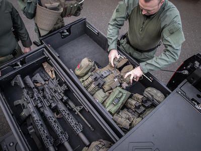 SWAT police removing gear from extended drawers of TruckVault secure storage for Ford F-150 pickup truck