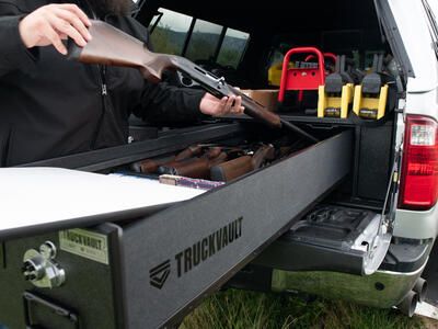 A man taking his rifle out of his TruckVault.