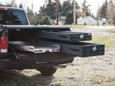 pickup truck with half width drawers stacked on passenger side and cargo glide on driver side drawers and glide extended