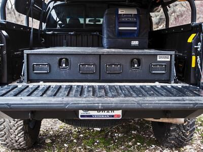 A Toyota Tacoma with a TruckVault secure storage system in the bed.