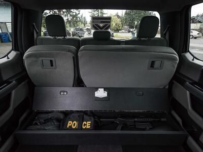 A SeatVault under the back seat of a Ford F150 used to store police gear.