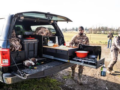 Hunter cooking out of TruckVault Base Camp line 5