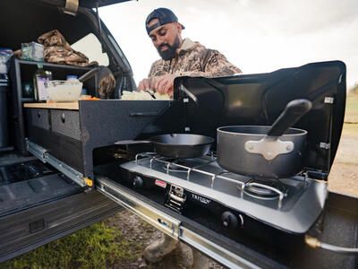 Hunter cooking out of TruckVault Base Camp line 5