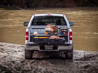 A Silver Ford F-150 All-Weather TruckVault filled with fishing gear.