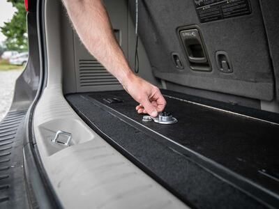 A man unlocking a Kia Sedona FloorVault.