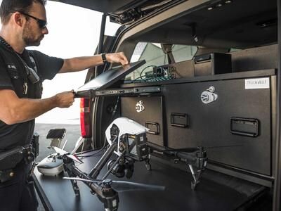 A police officer opening his drone viewing screen on his TruckVault.