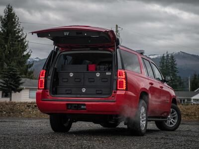 The back of a red, open Chevy Suburban with a custom TruckVault.