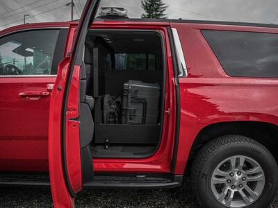 A view inside the read door of a red, fire department Chevy Suburban with a Custom TruckVault inside.