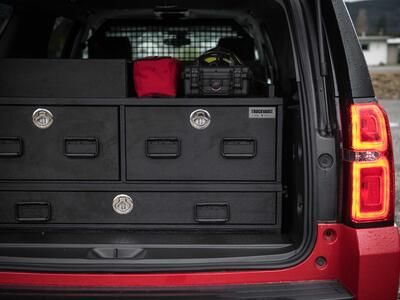 The back of an red, open fire department Chevy Suburban with a custom TruckVault.