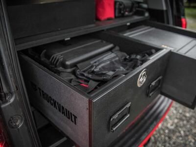 An up-close image of a custom, open TruckVault inside of a red Chevy Suburban.